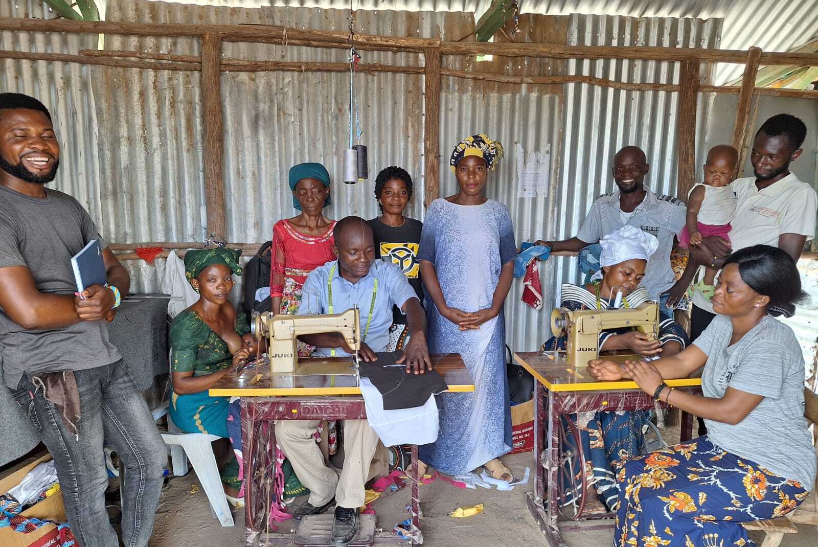 Members learning tailoring and sewing with machines during a skills training