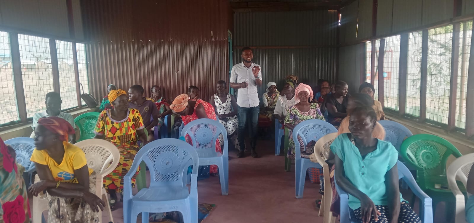 A facilitator speaking to members during a business skills training session